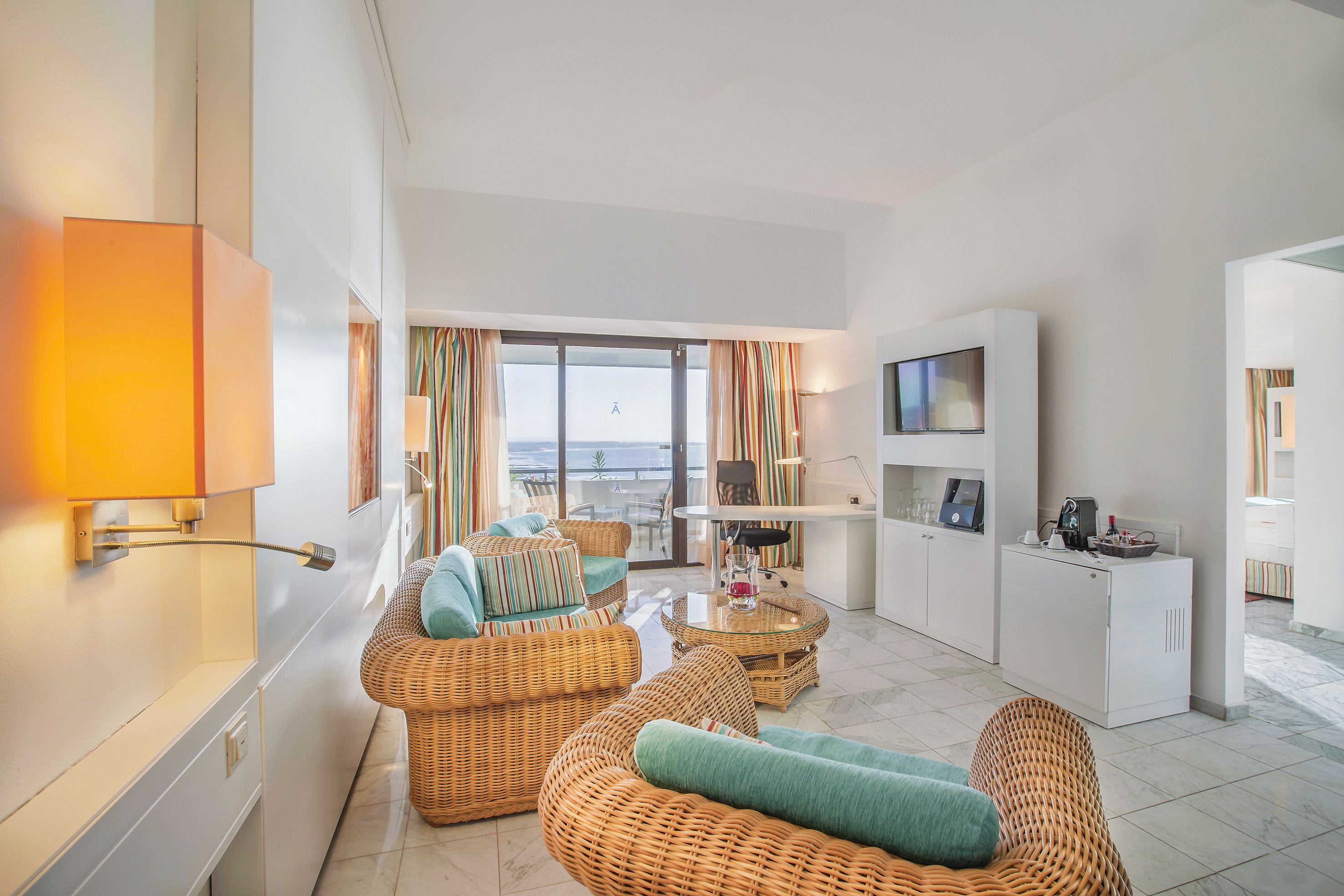 a room with wicker furniture and a television