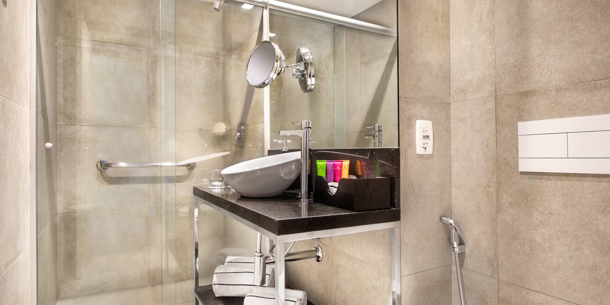 a bathroom with a glass shower and sink