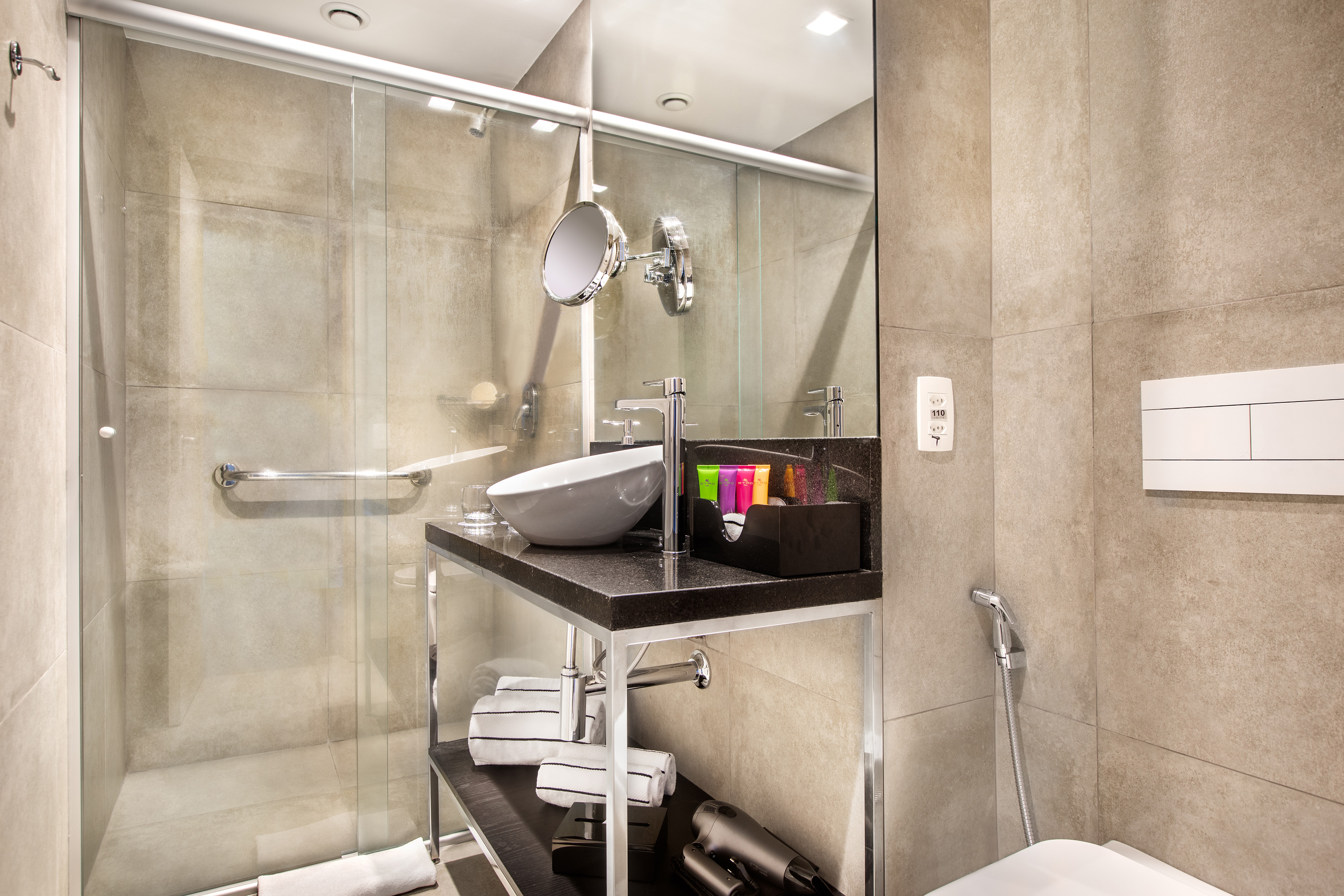 a bathroom with a glass shower and sink