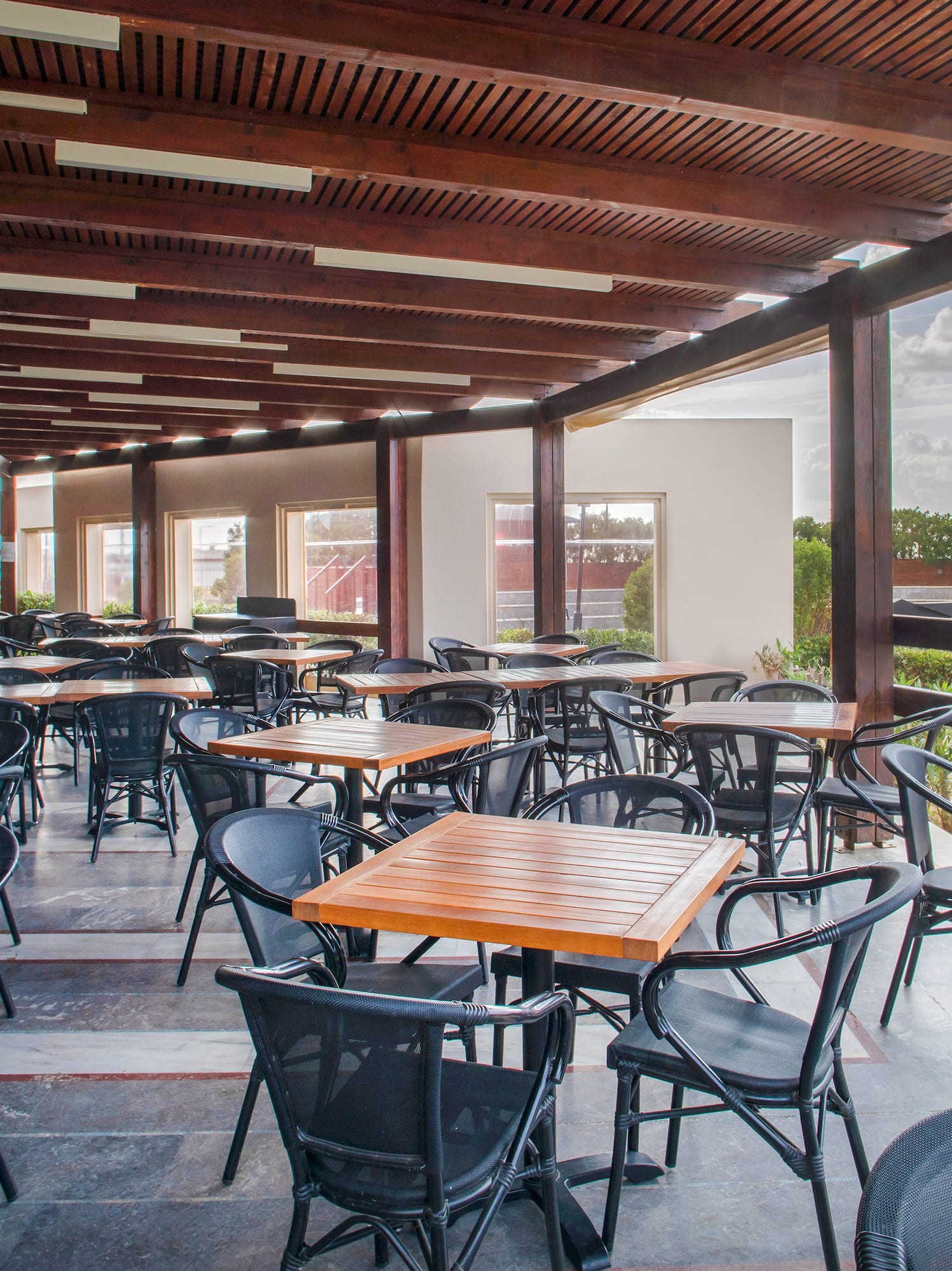 a patio with tables and chairs