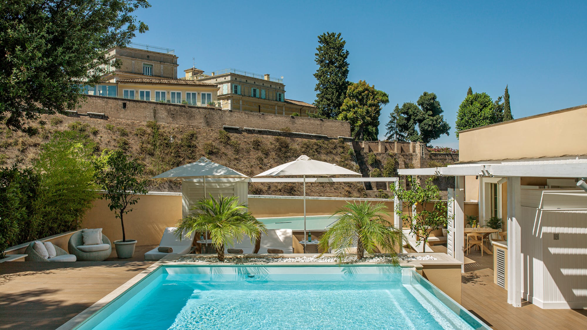 a pool with trees and a building in the background