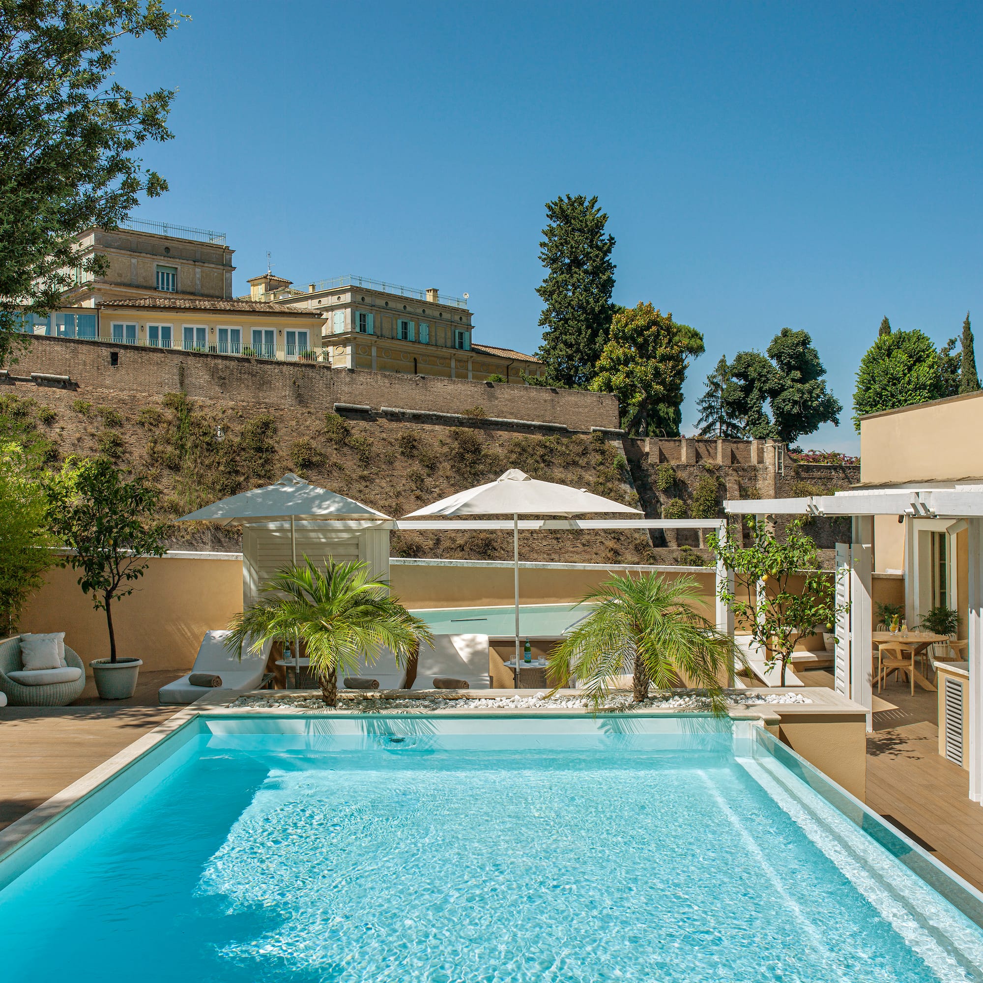 a pool with trees and a building in the background