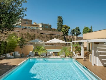 a pool with trees and a building in the background
