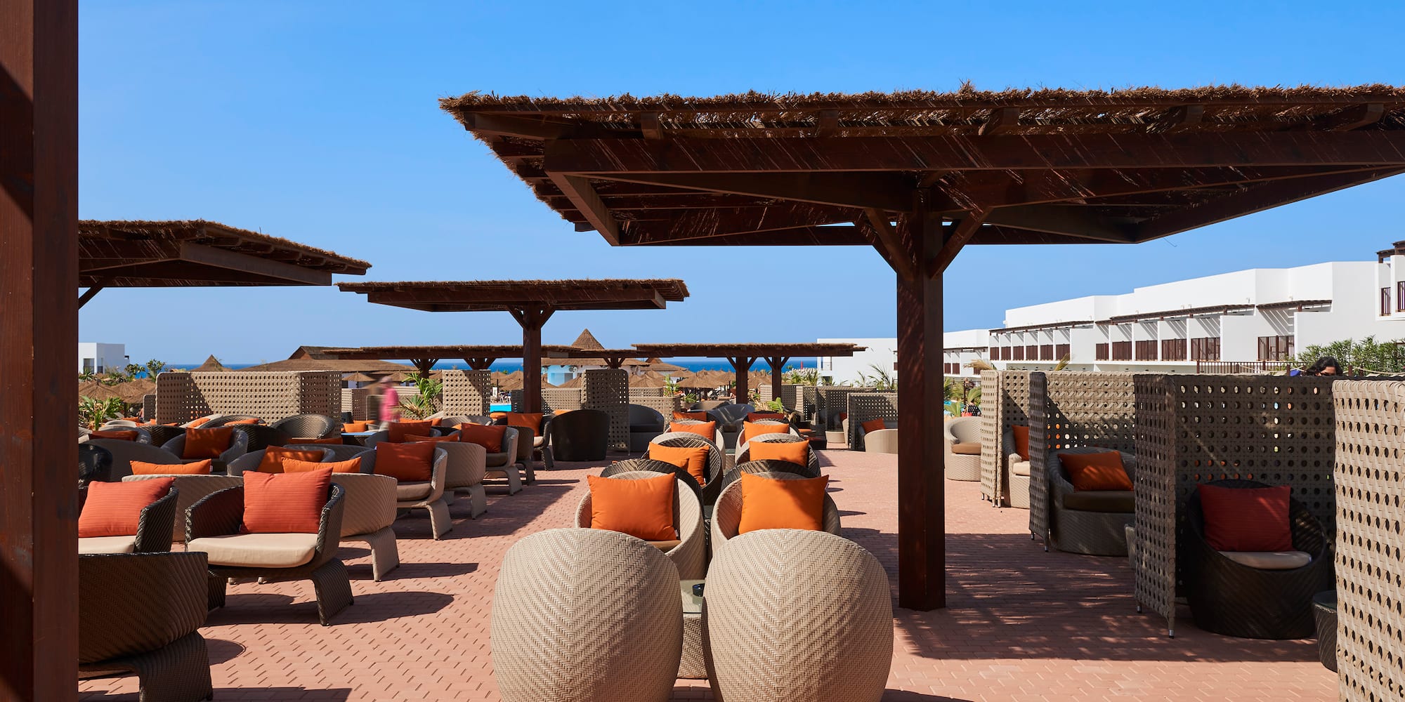 a patio with chairs and umbrellas