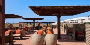 a patio with chairs and umbrellas