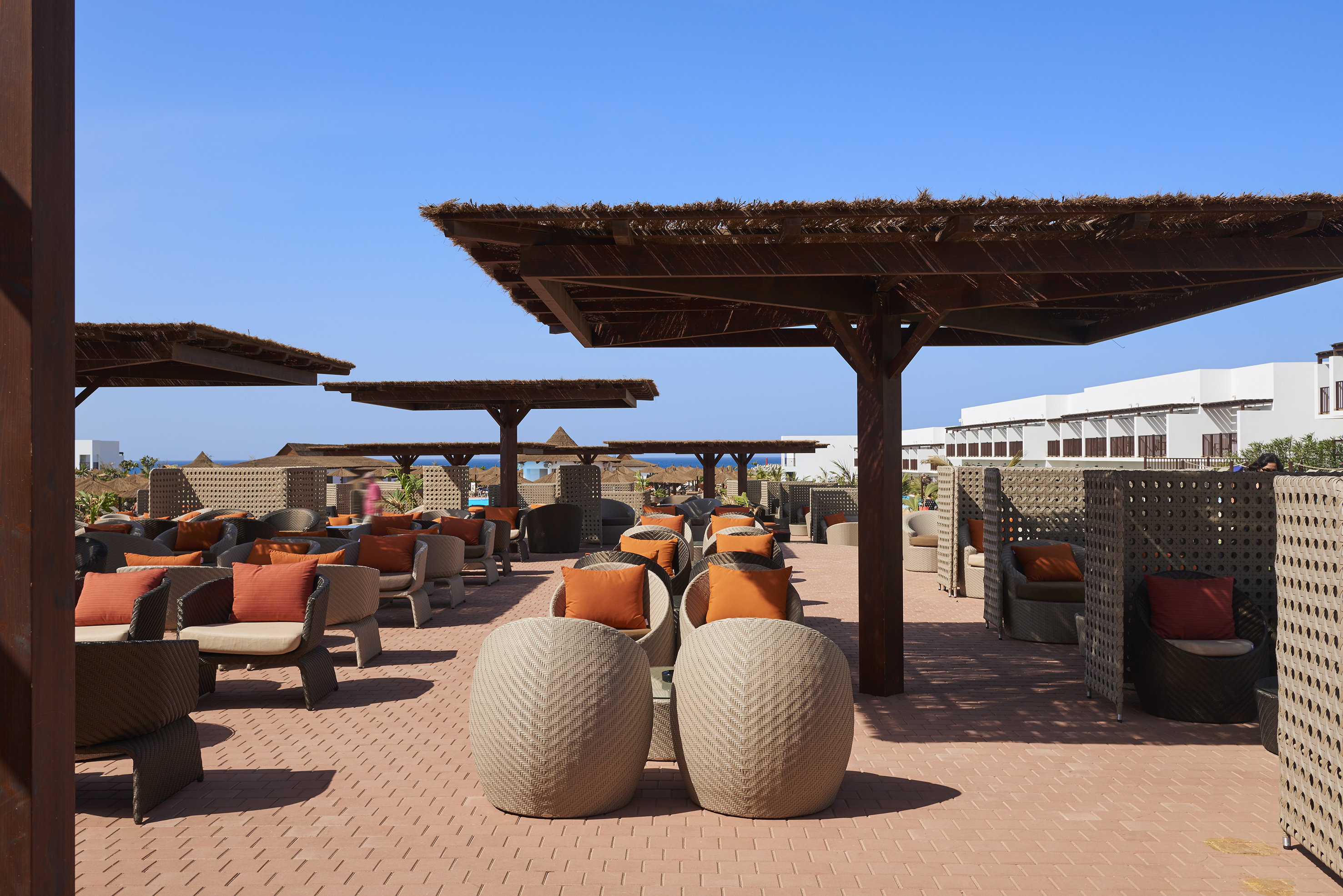 a patio with chairs and umbrellas