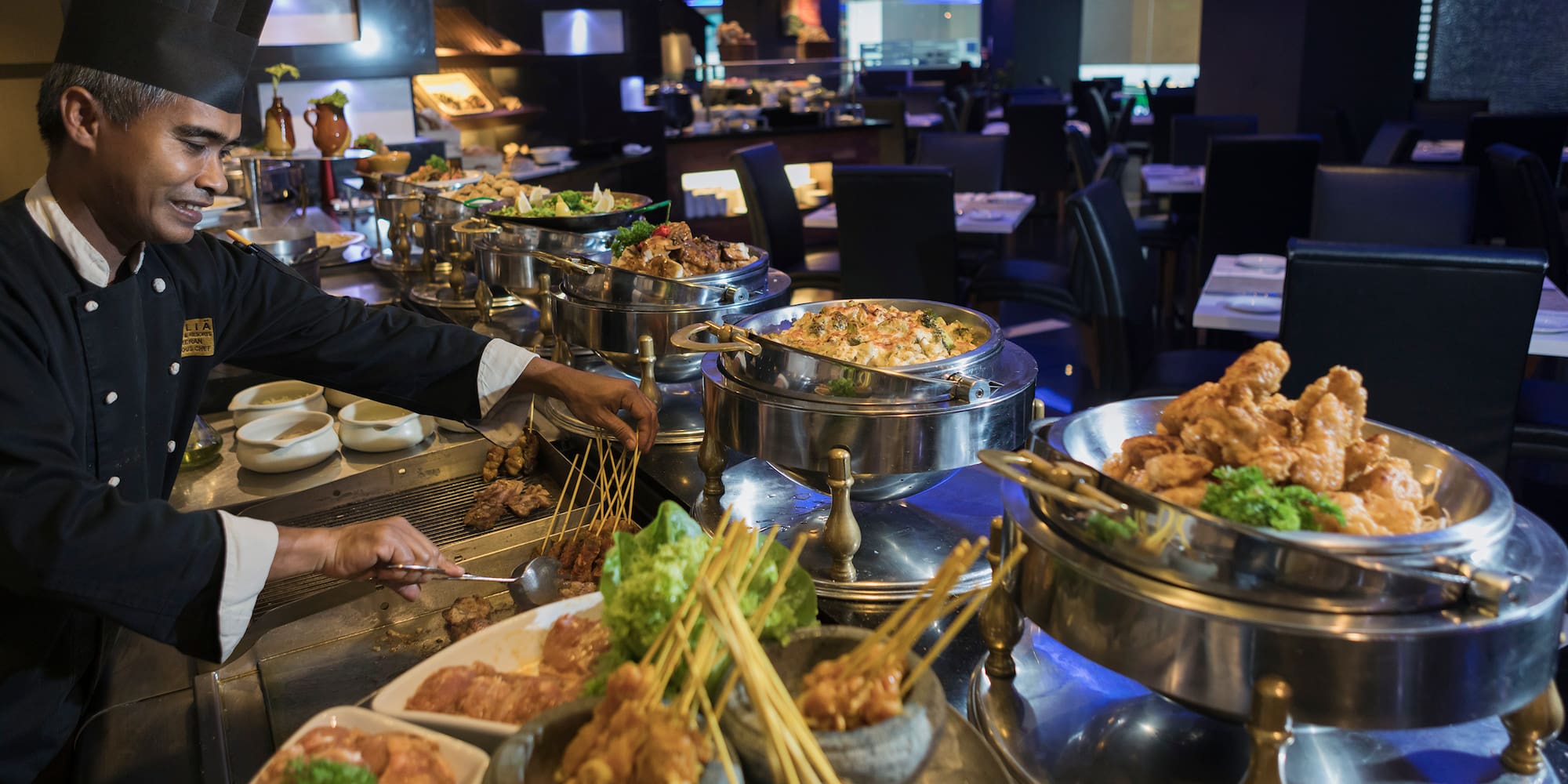 a group of people cooking food in a restaurant