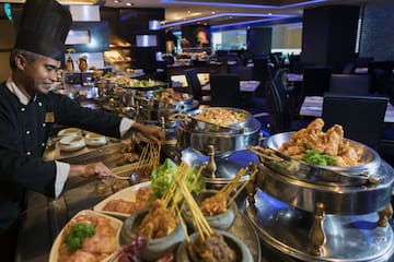 a group of people cooking food in a restaurant
