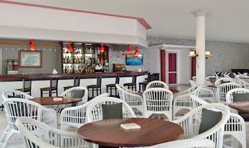 a bar with tables and chairs