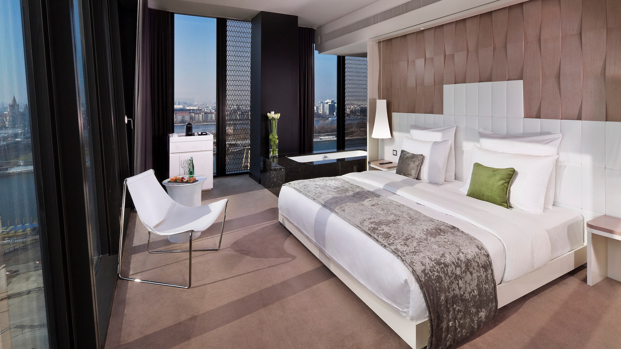 a bedroom with a bed and a chair