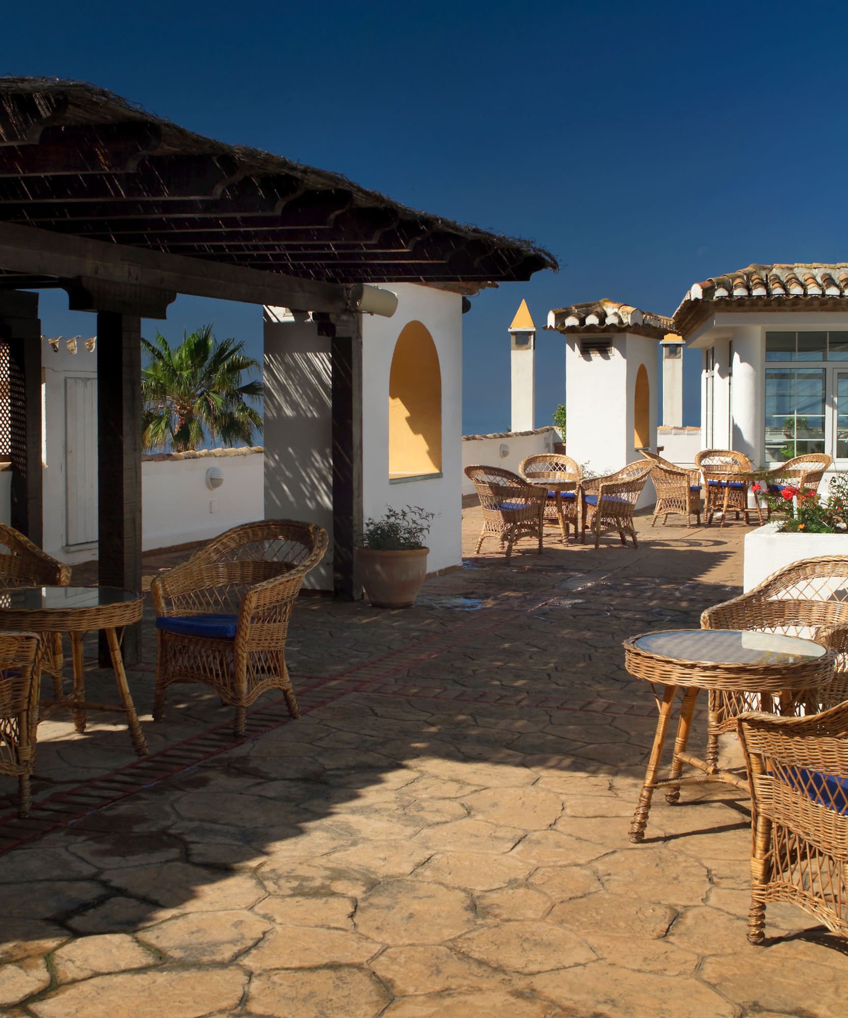 a patio with chairs and tables