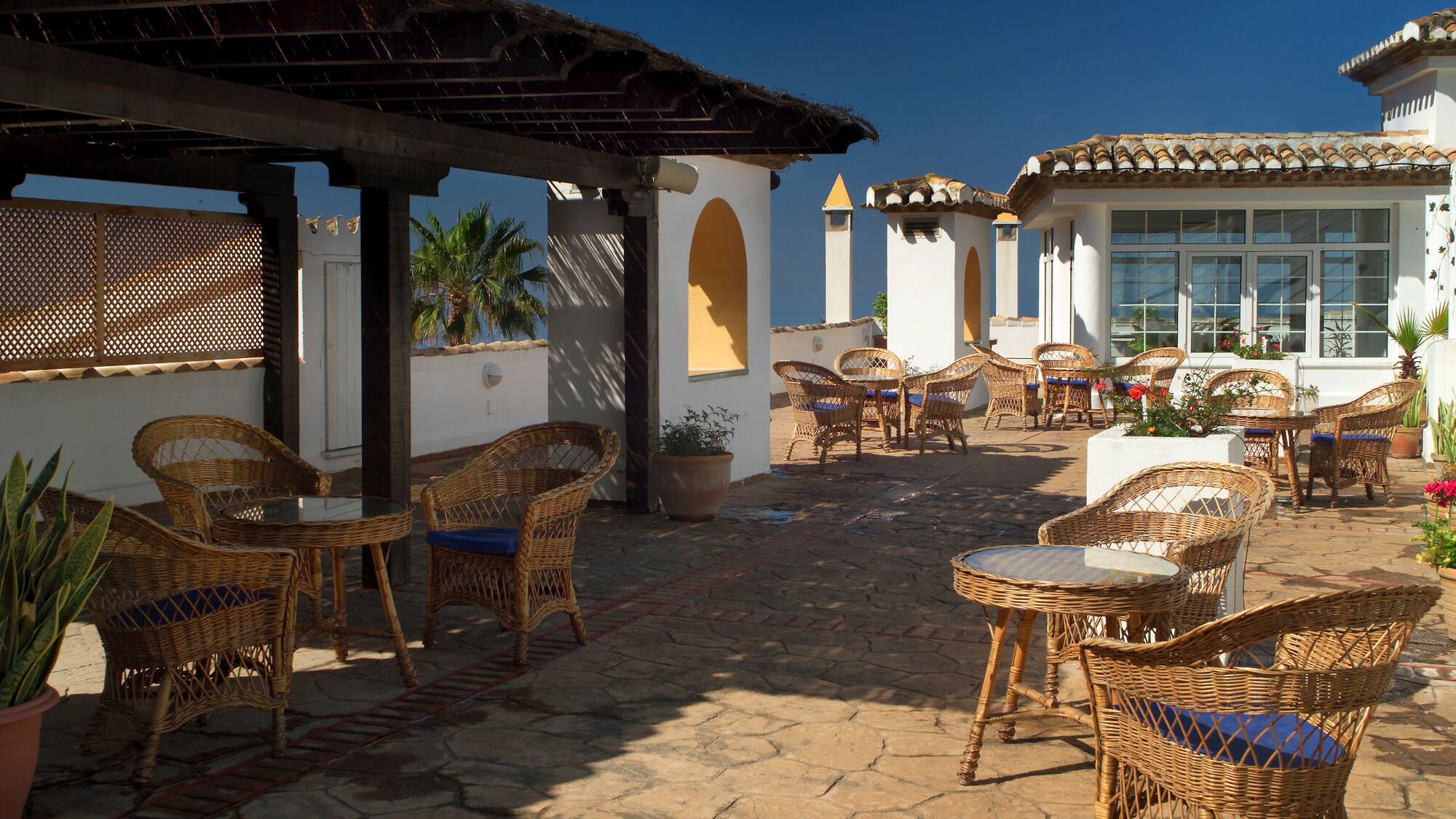a patio with chairs and tables