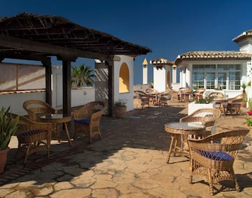 a patio with chairs and tables