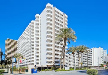 a large white building with palm trees