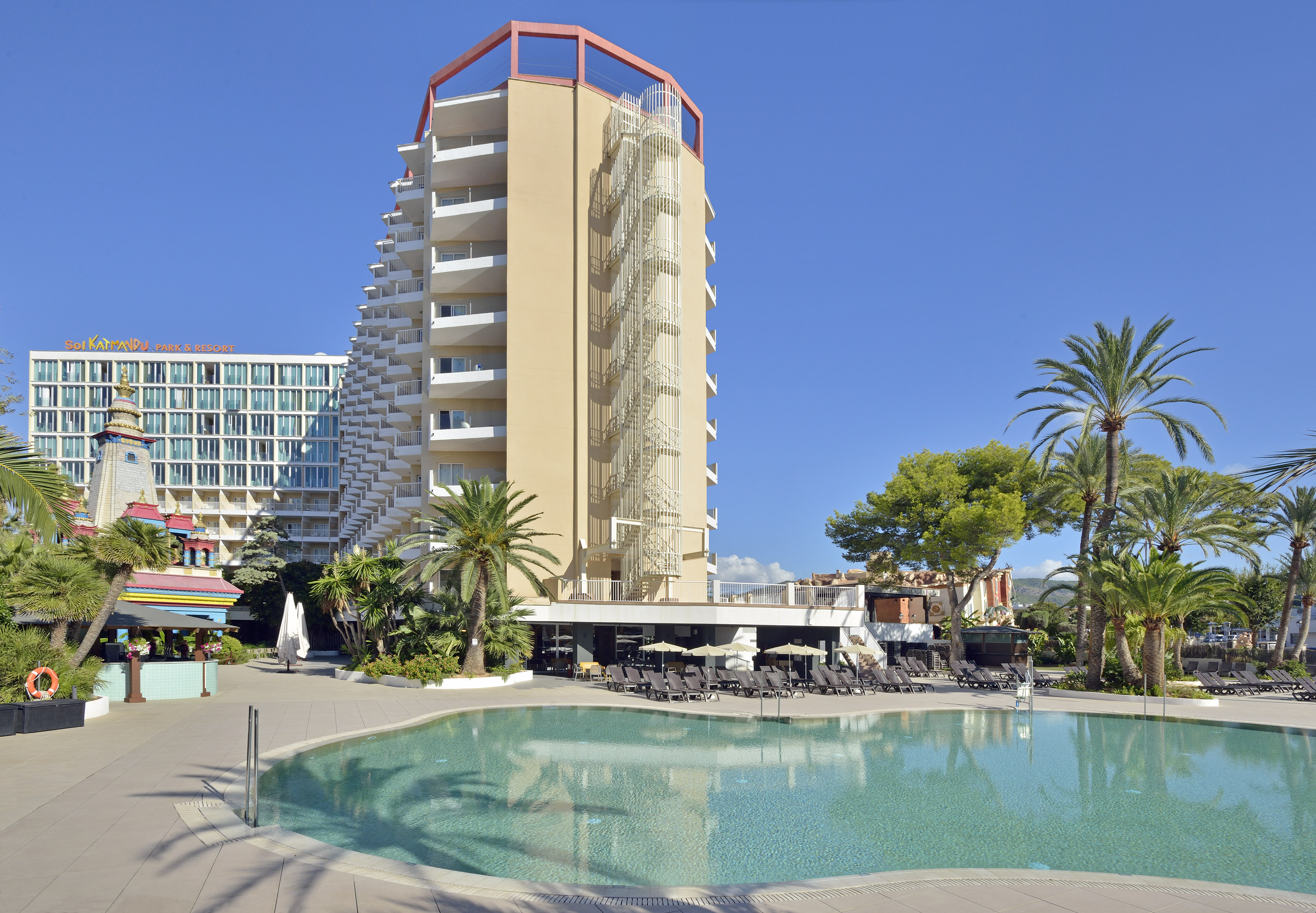 Sol Katmandu Park & Resort hotel with large swimming pool, palm trees, sunny day.