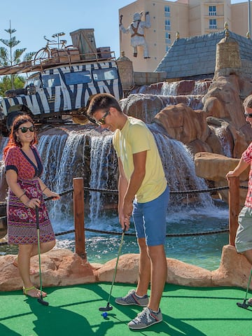 a group of people playing mini golf
