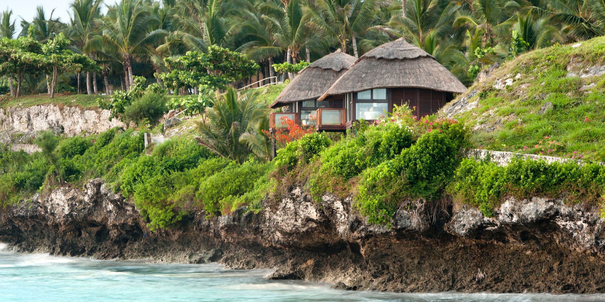 a house on a cliff by the water