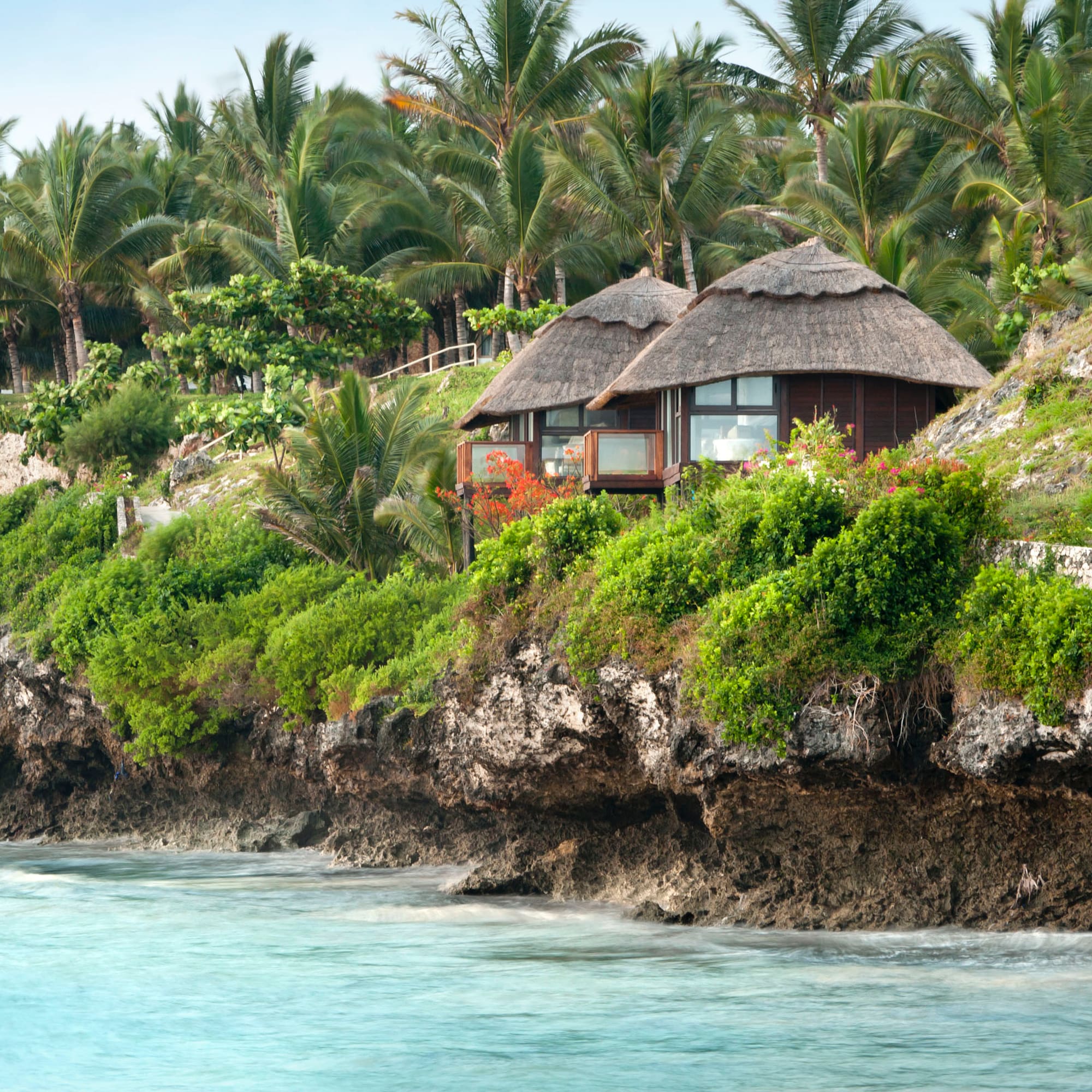 a house on a cliff by the water