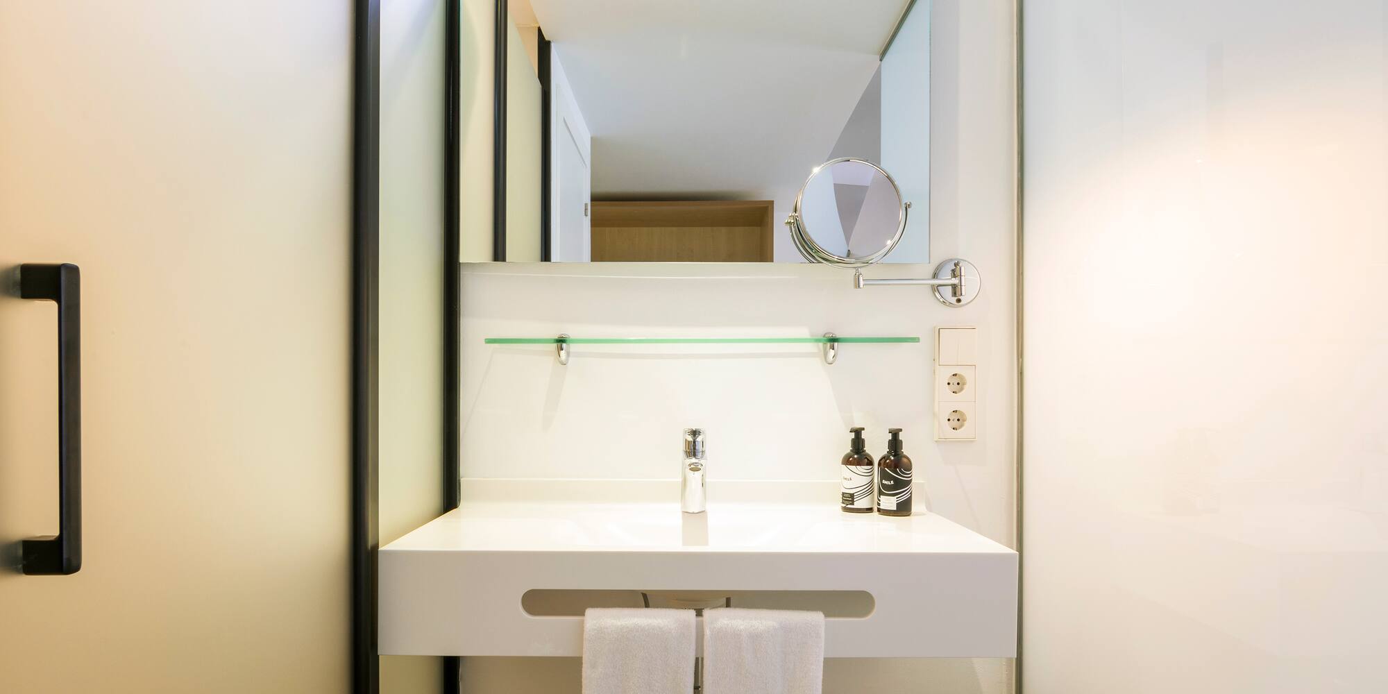 a bathroom sink with a mirror and a mirror