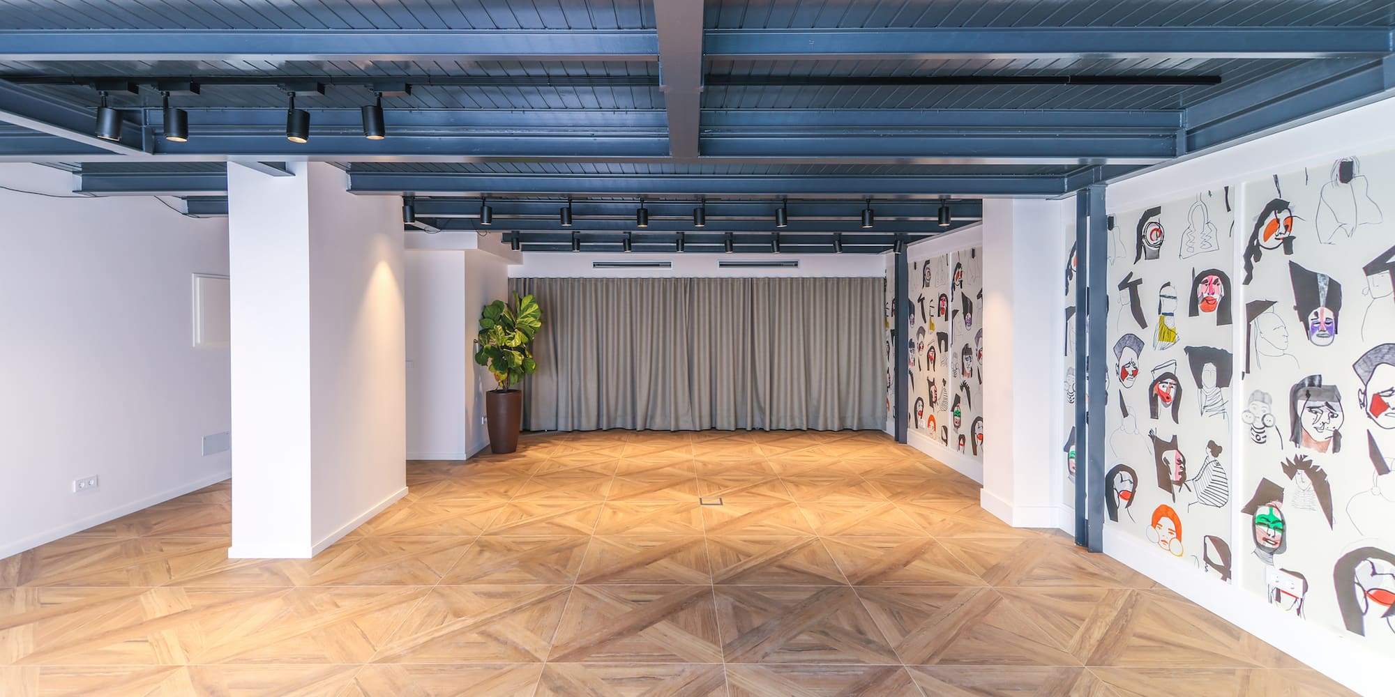 a room with a wood floor and a curtain