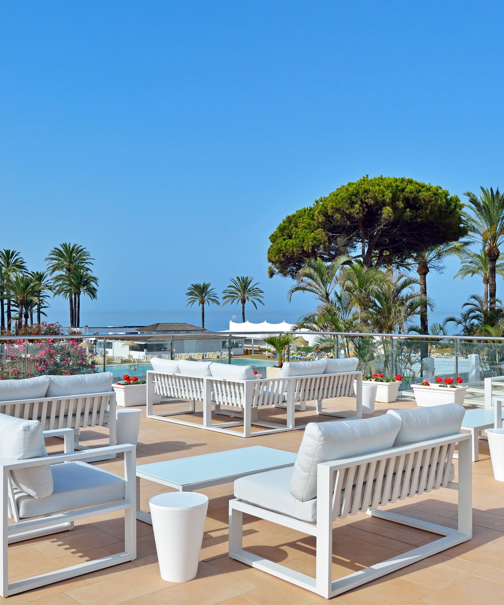 a white chairs and tables on a patio