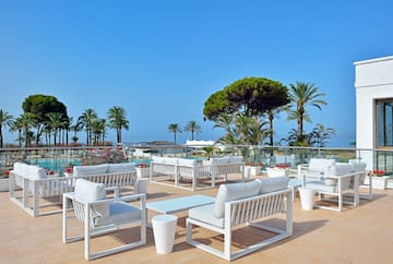 a white chairs and tables on a patio