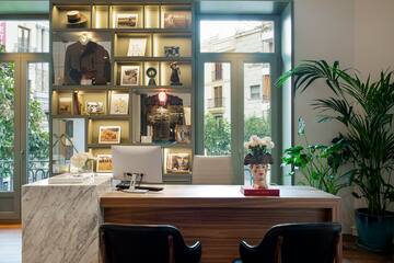a desk with a computer and a plant in front of it
