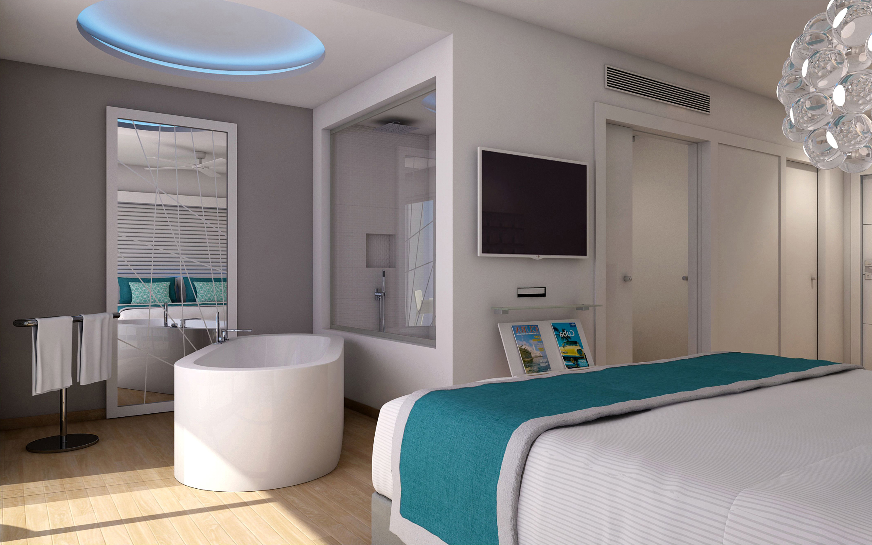 a bedroom with a tub and a tv