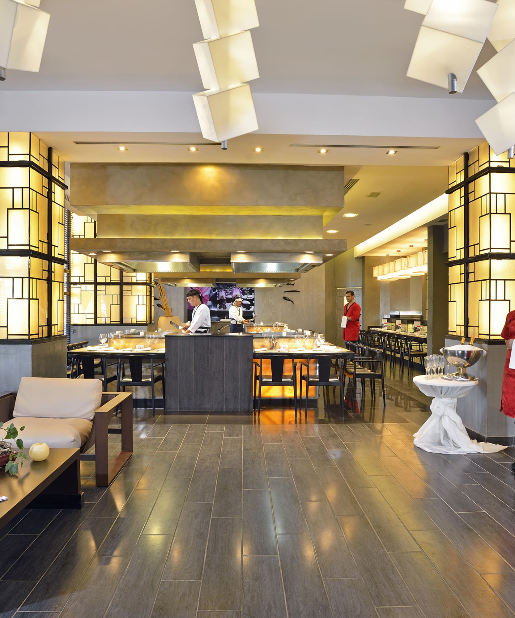 a restaurant with a woman standing in front of a buffet