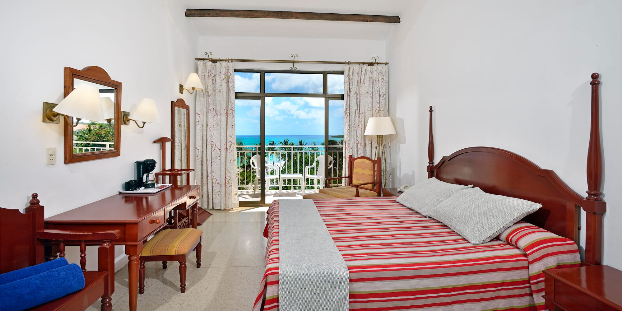 a bedroom with a bed and a desk and a chair