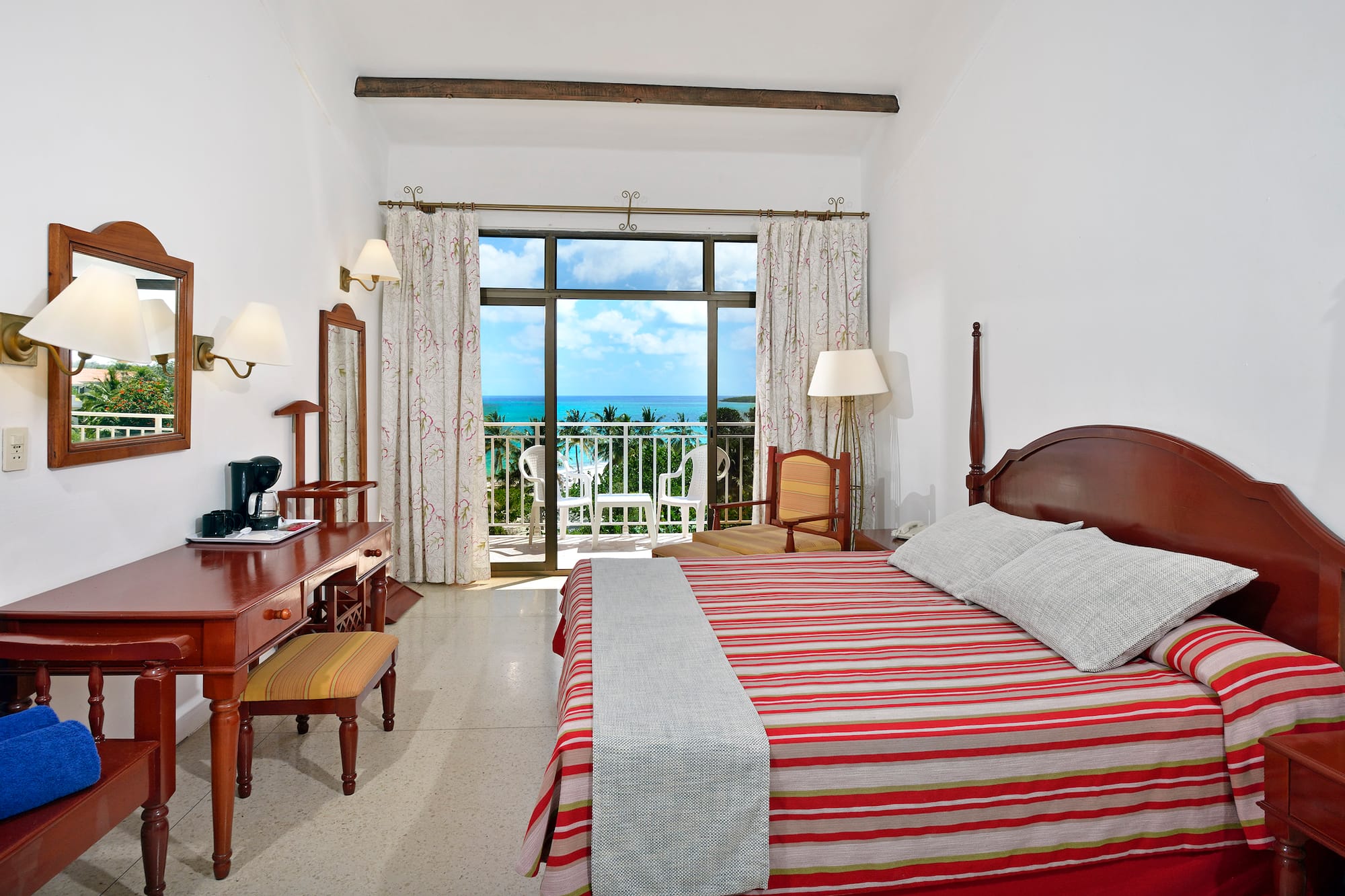 a bedroom with a bed and a desk and a chair