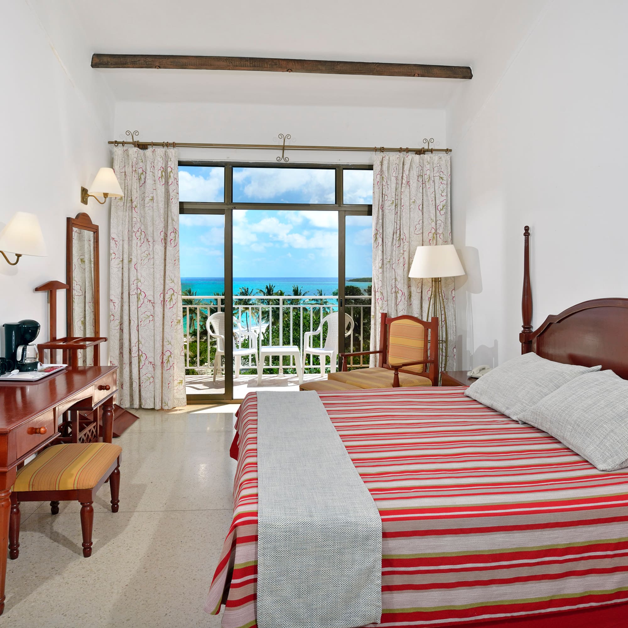 a bedroom with a bed and a desk and a chair