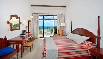 a bedroom with a bed and a desk and a chair