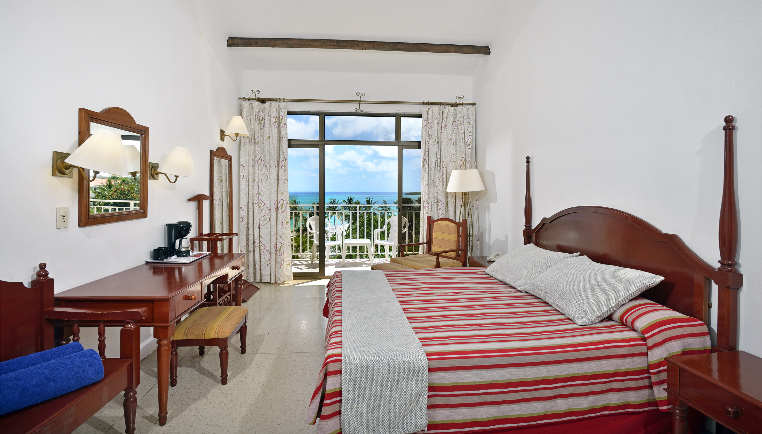 a bedroom with a bed and a desk and a chair