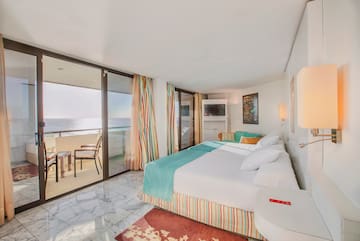 a room with a bed and a glass door