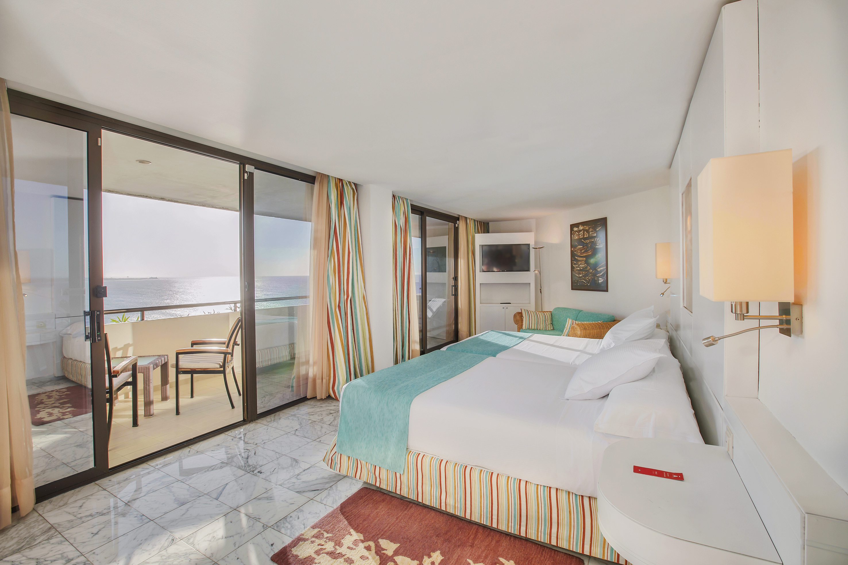 a room with a bed and a glass door