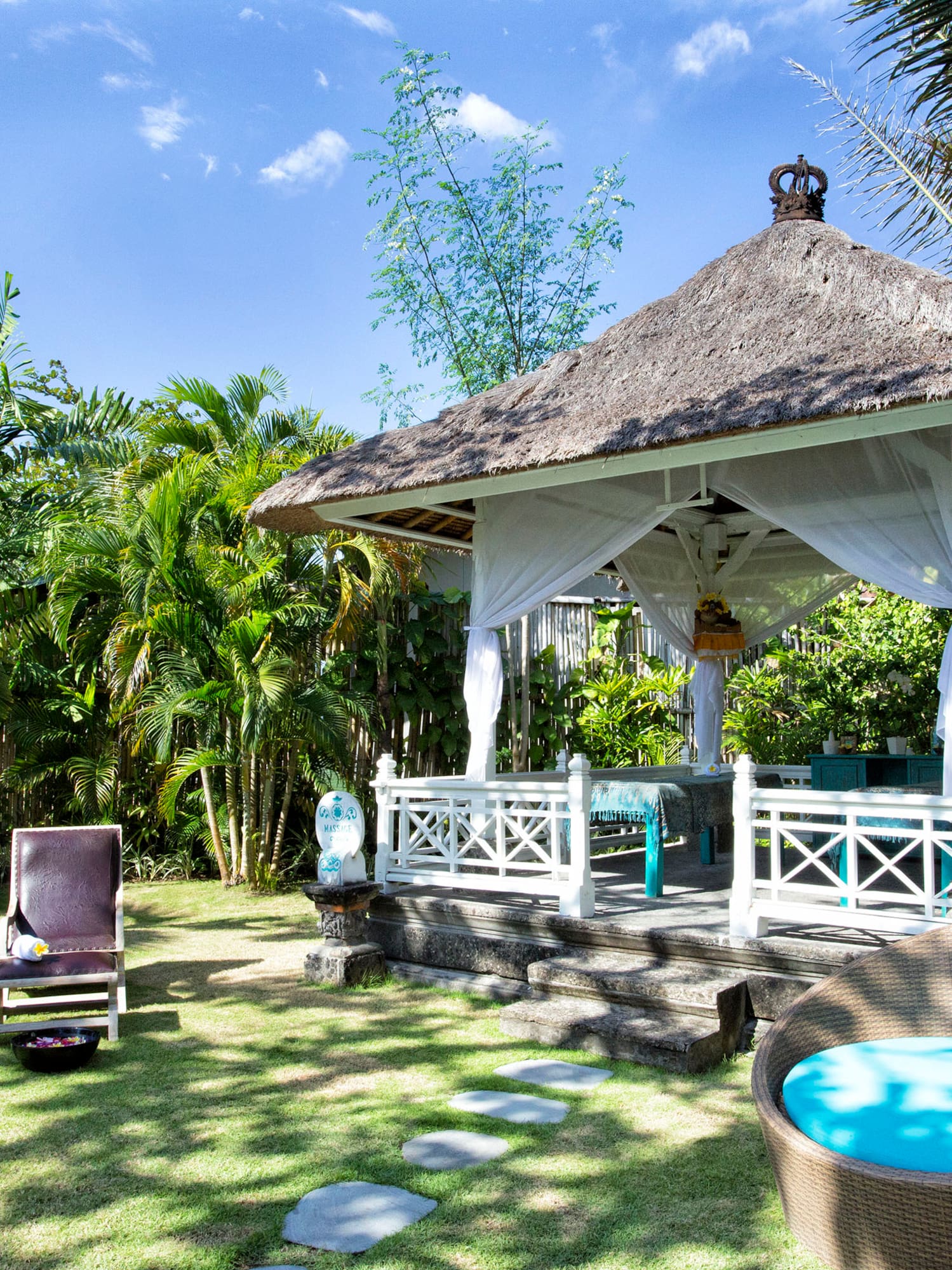a gazebo with chairs and a lawn chair