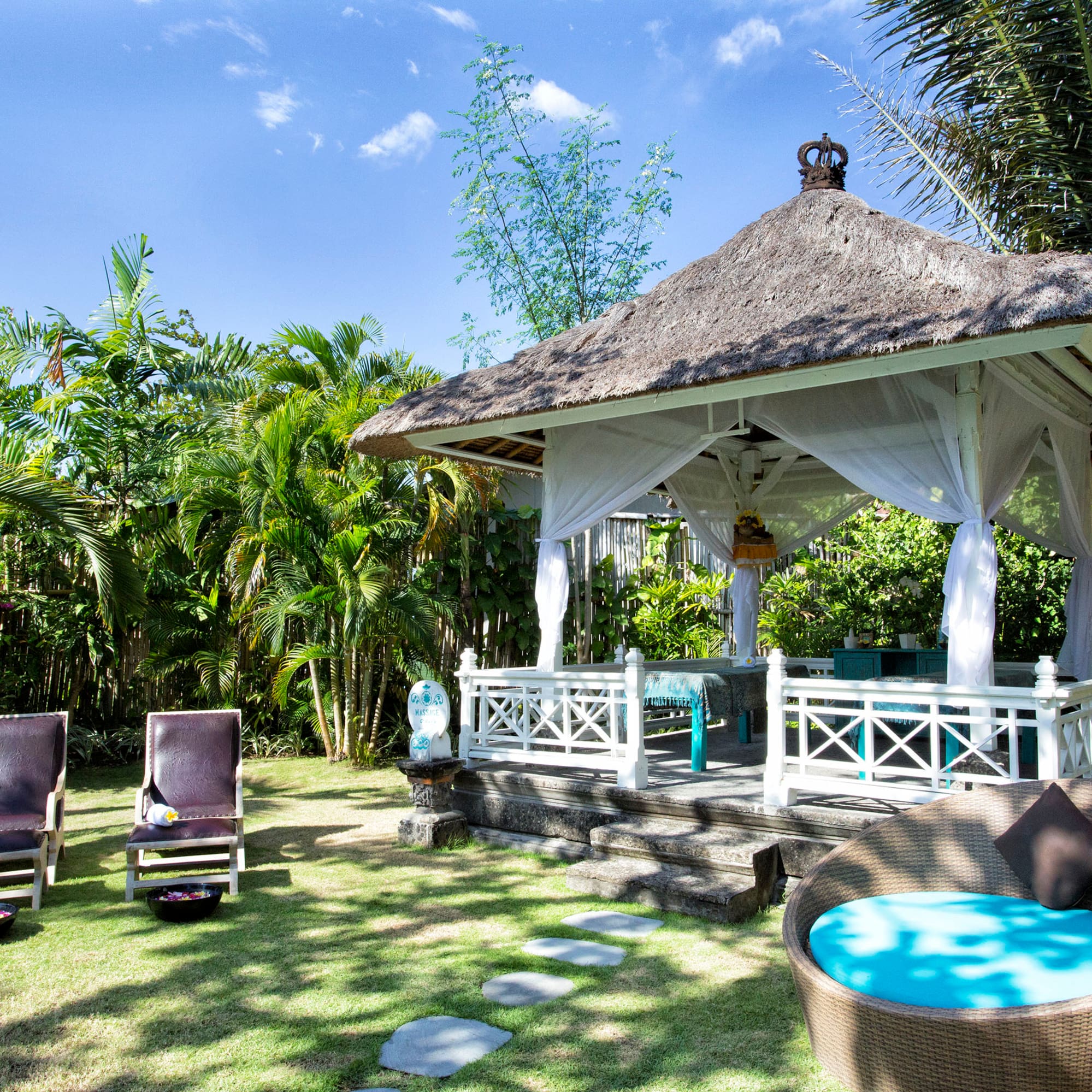a gazebo with chairs and a lawn chair
