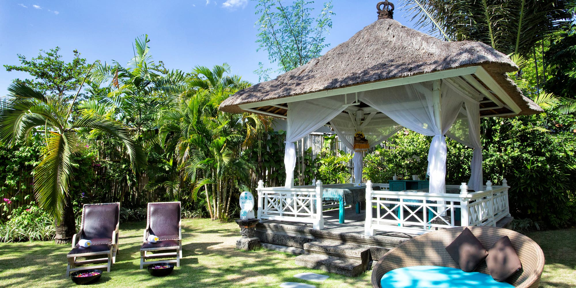 a gazebo with chairs and a lawn chair