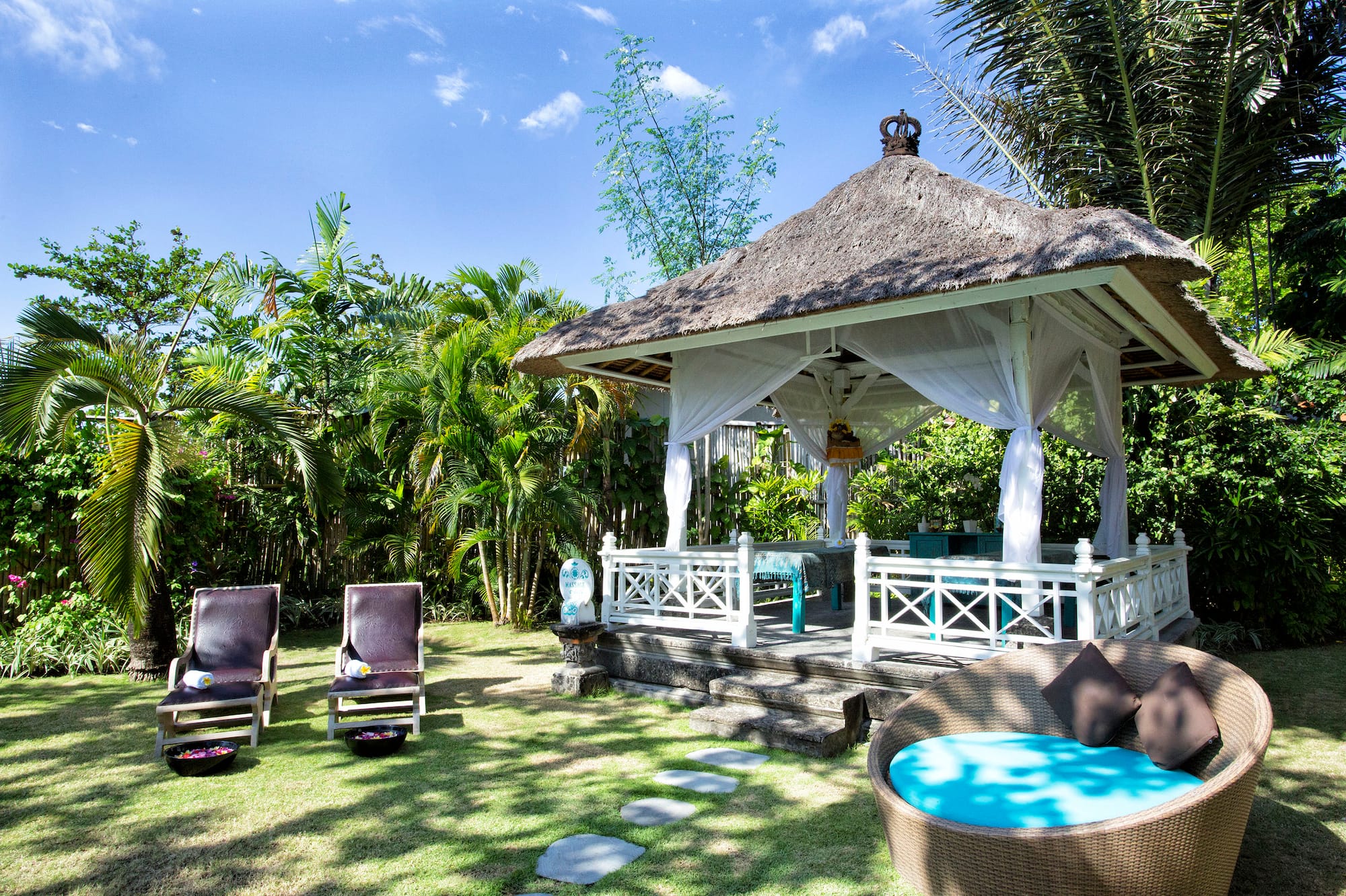 a gazebo with chairs and a lawn chair