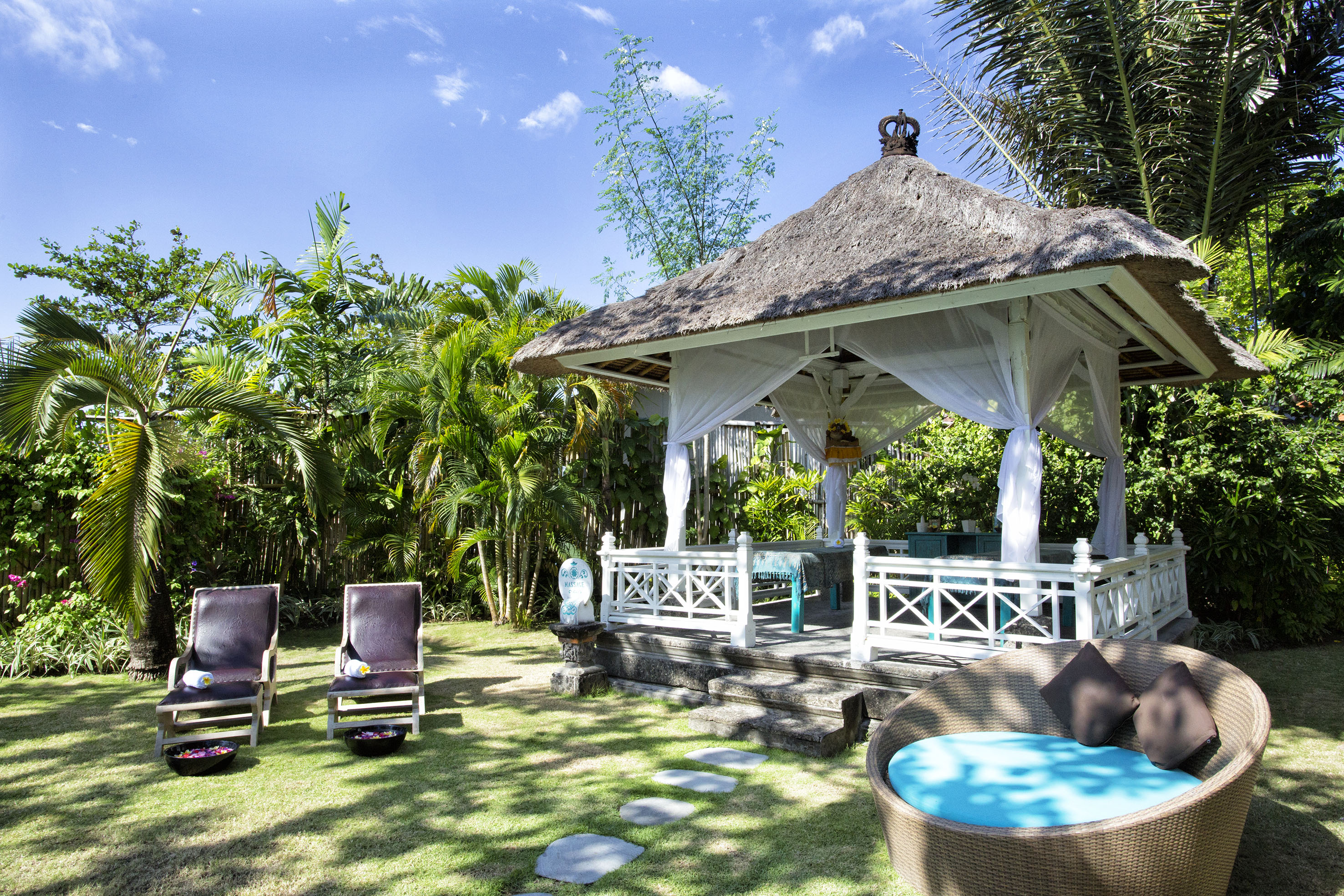 a gazebo with chairs and a lawn chair