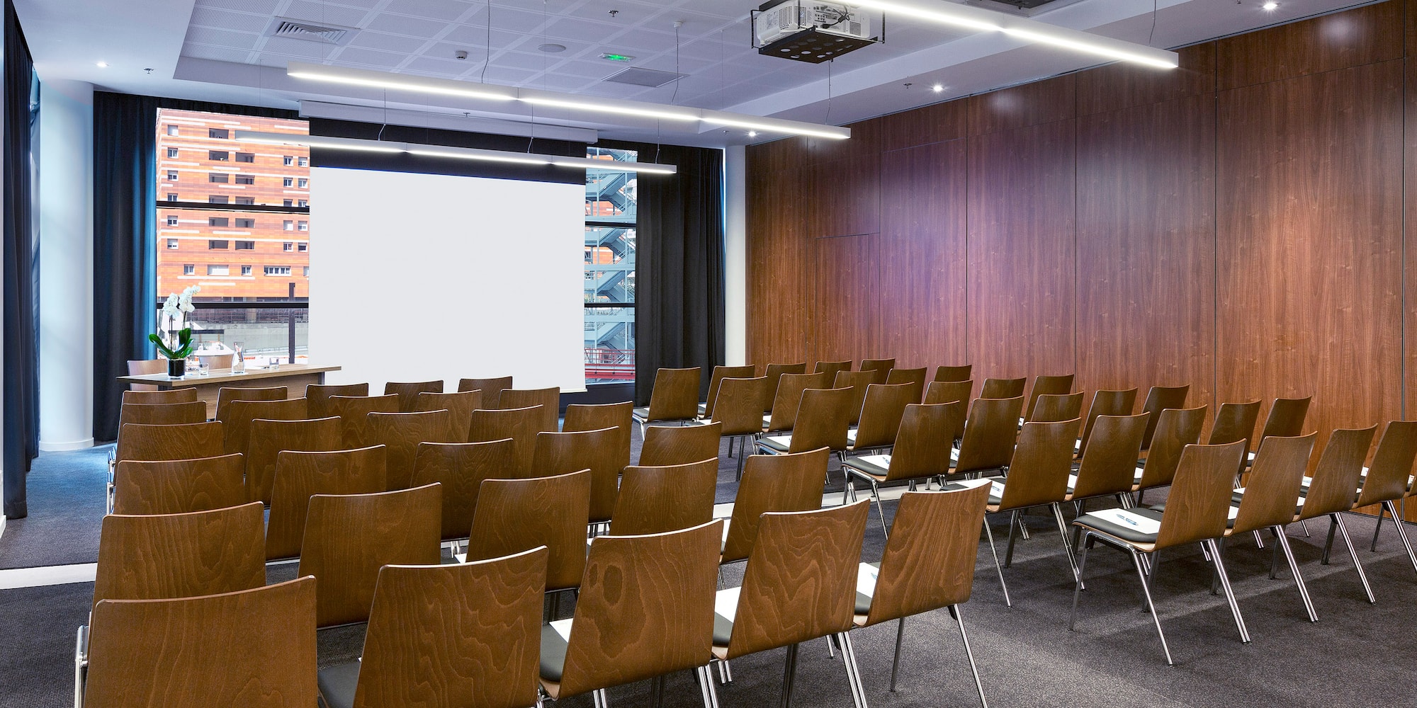 a room with chairs and a projector screen