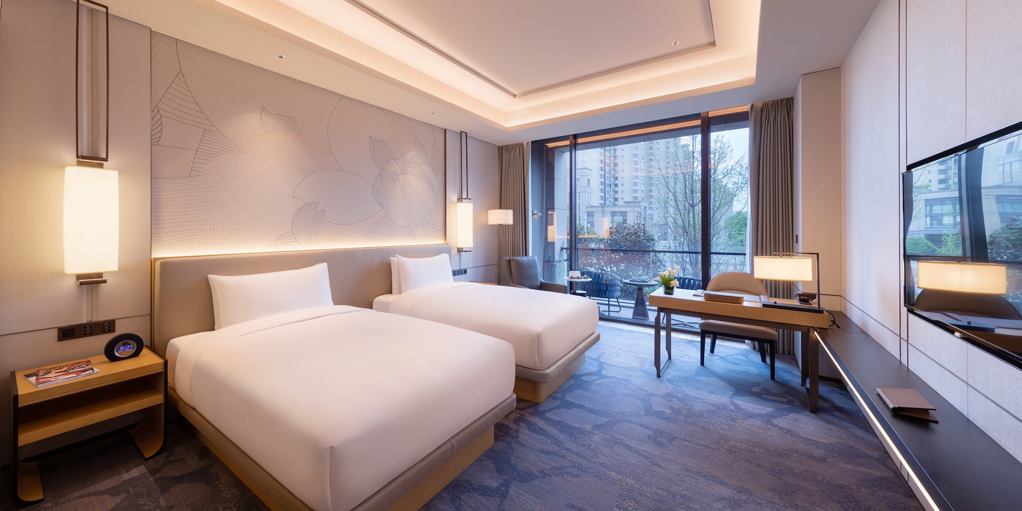 a room with two beds and a desk