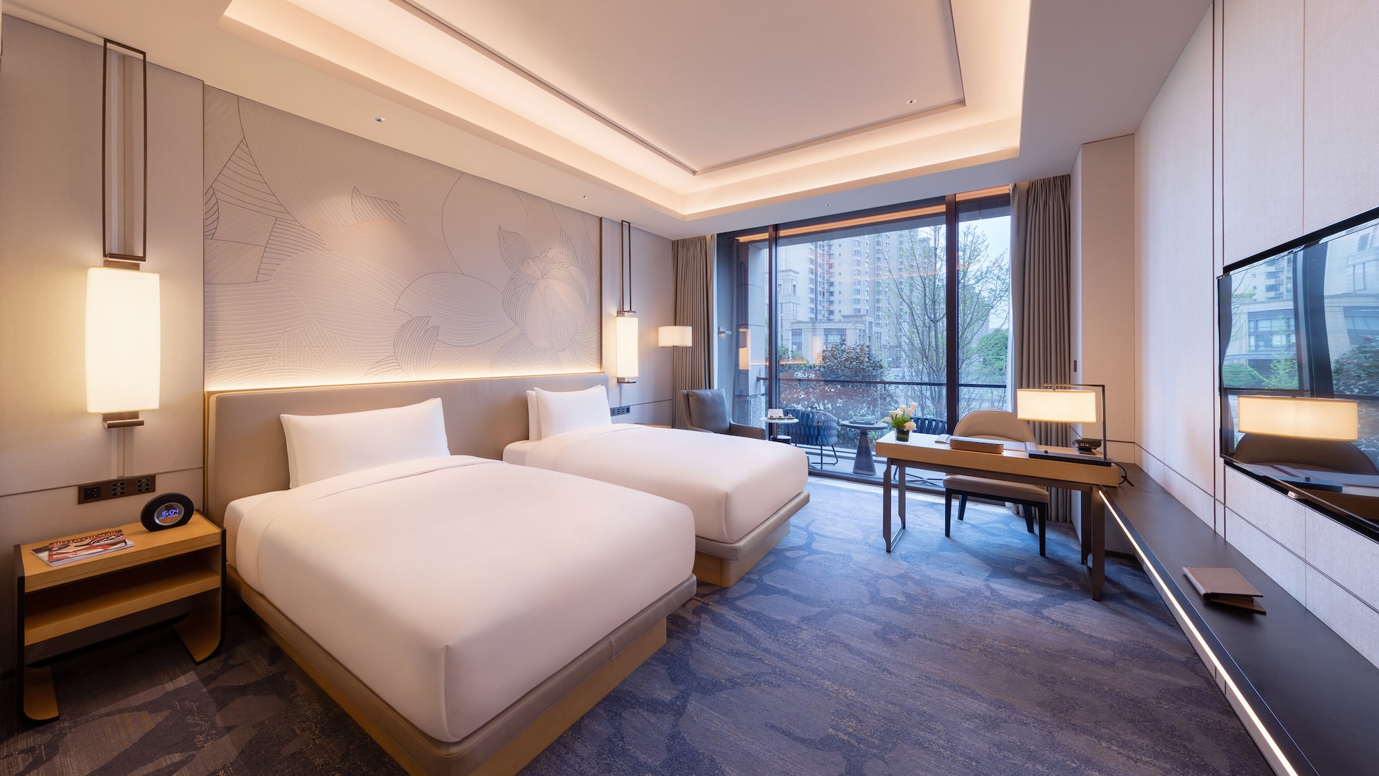 a room with two beds and a desk