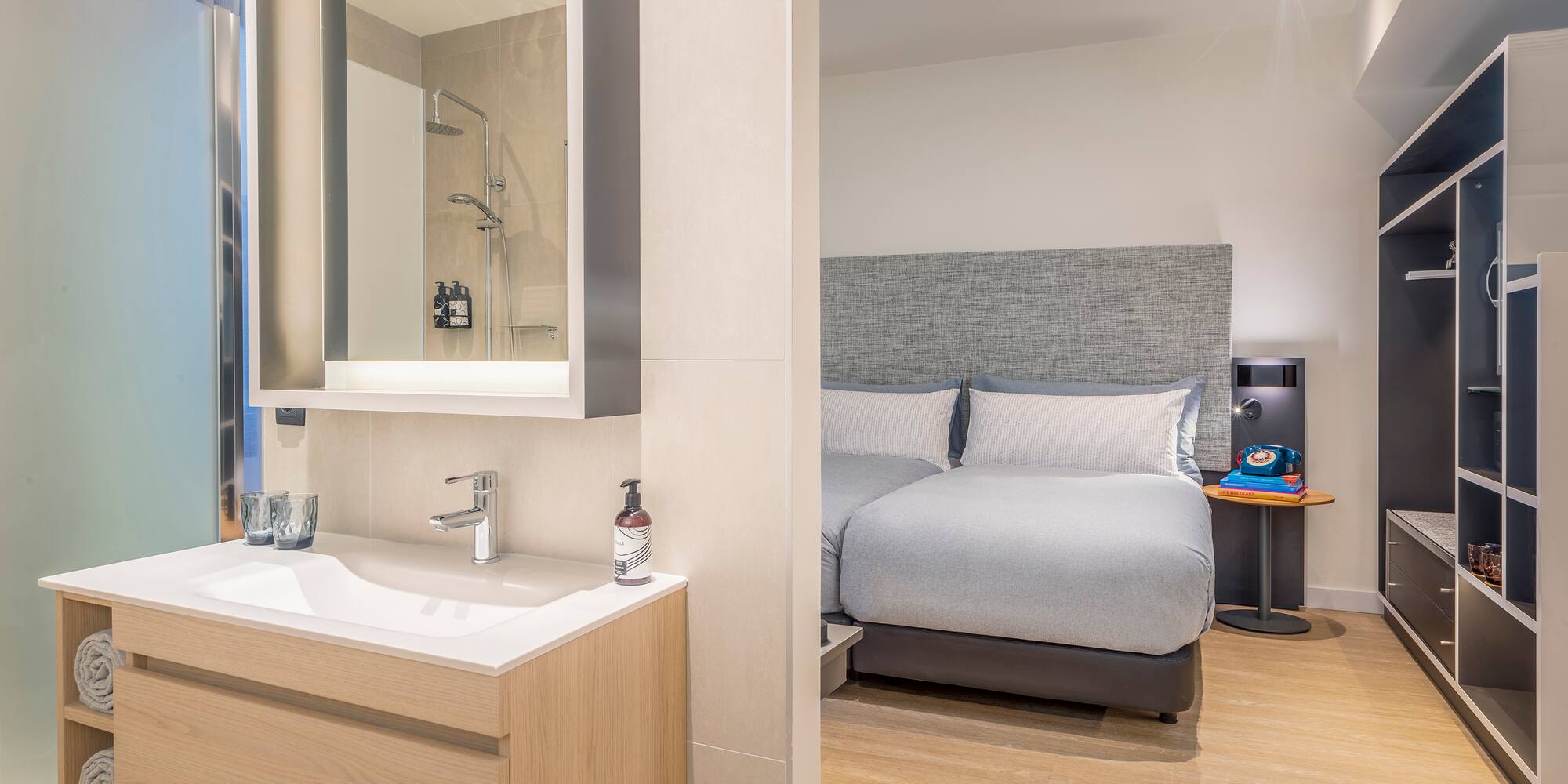 a bathroom with a bed and sink