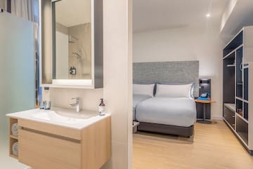 a bathroom with a bed and sink