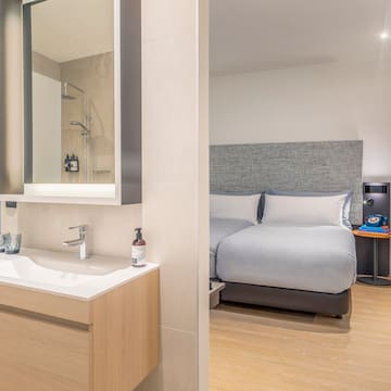 a bathroom with a bed and sink