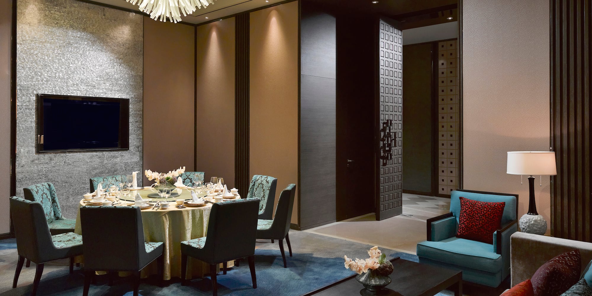 a room with a round table and chairs