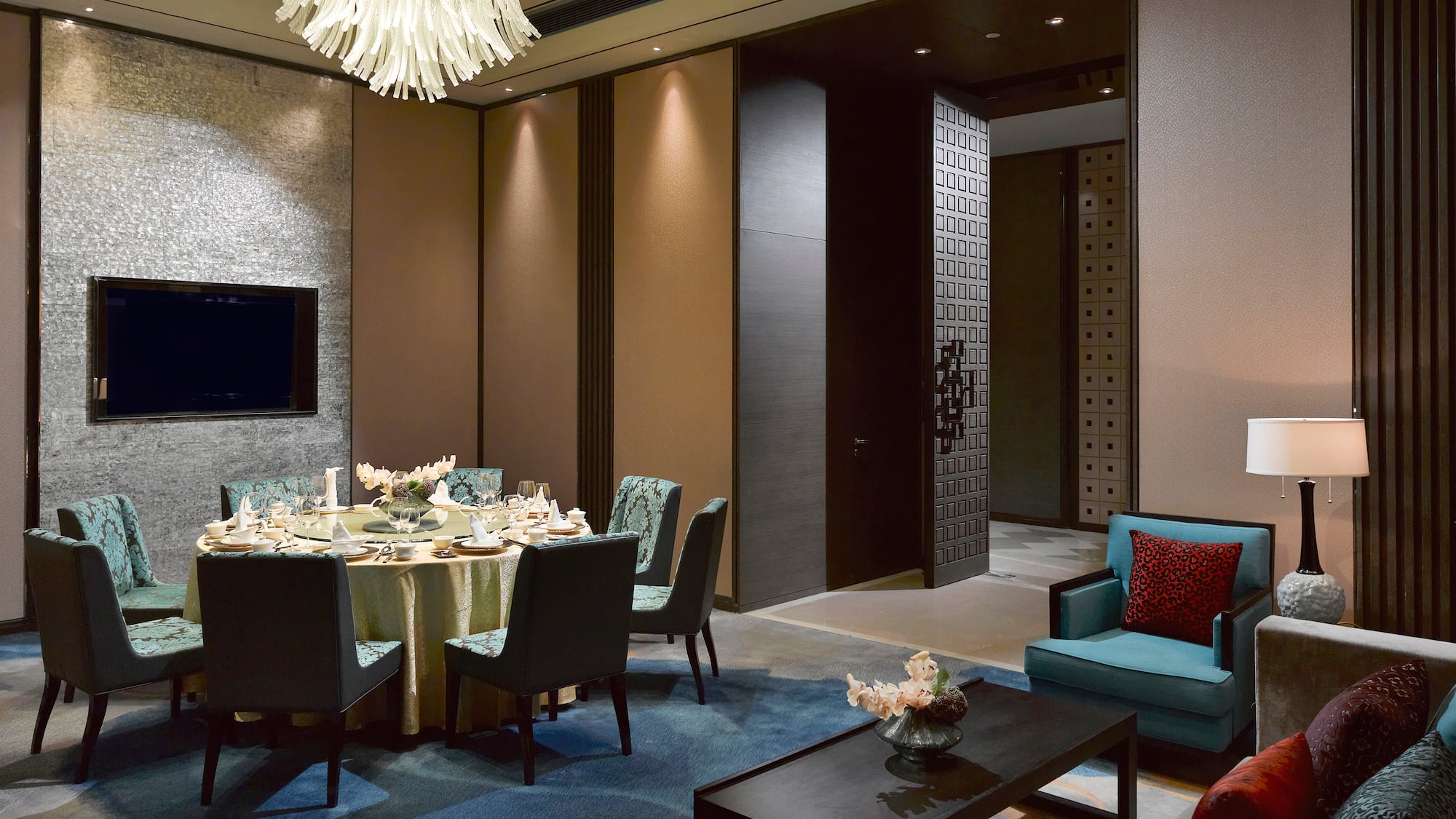 a room with a round table and chairs