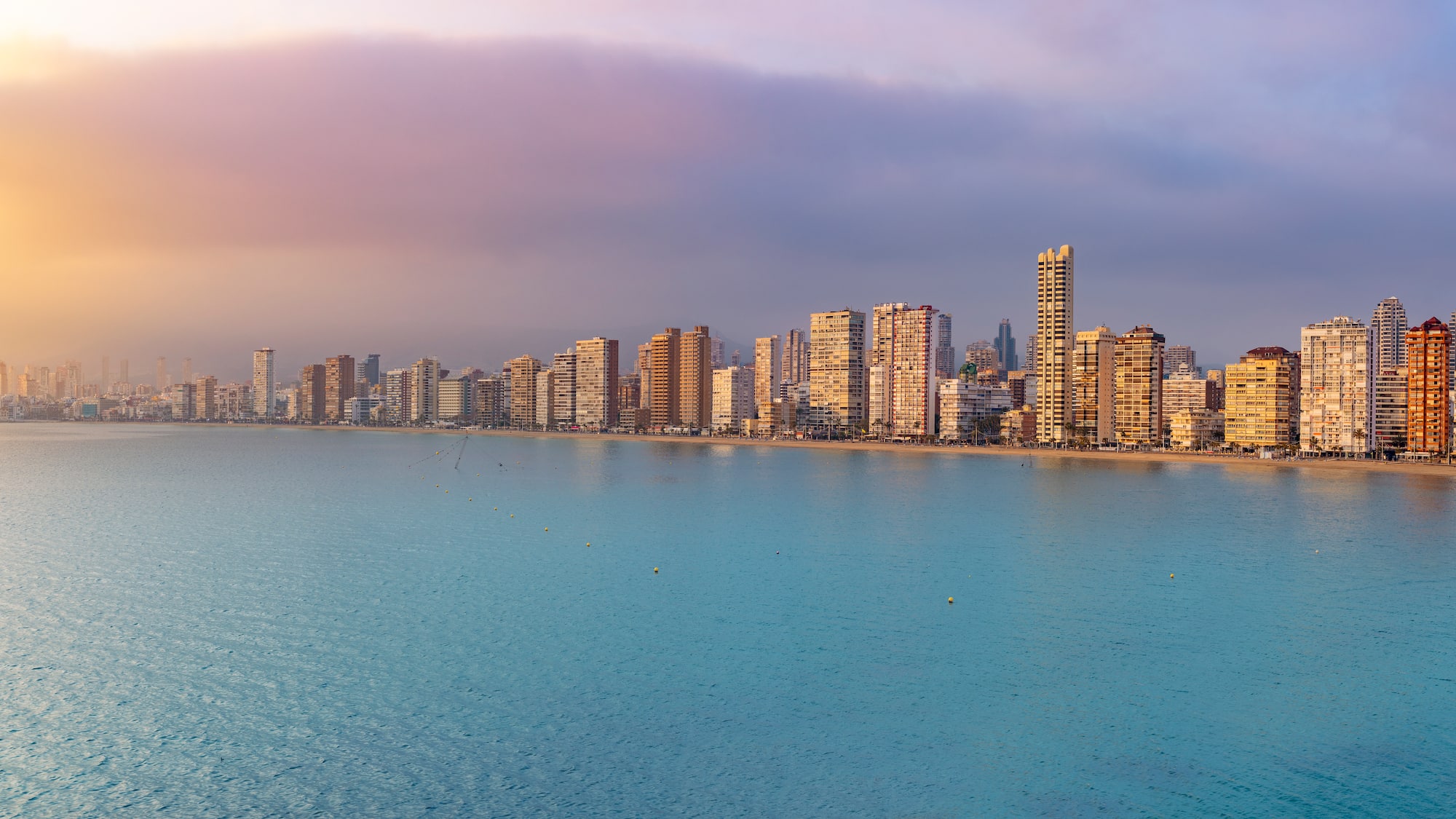 a city skyline with a body of water